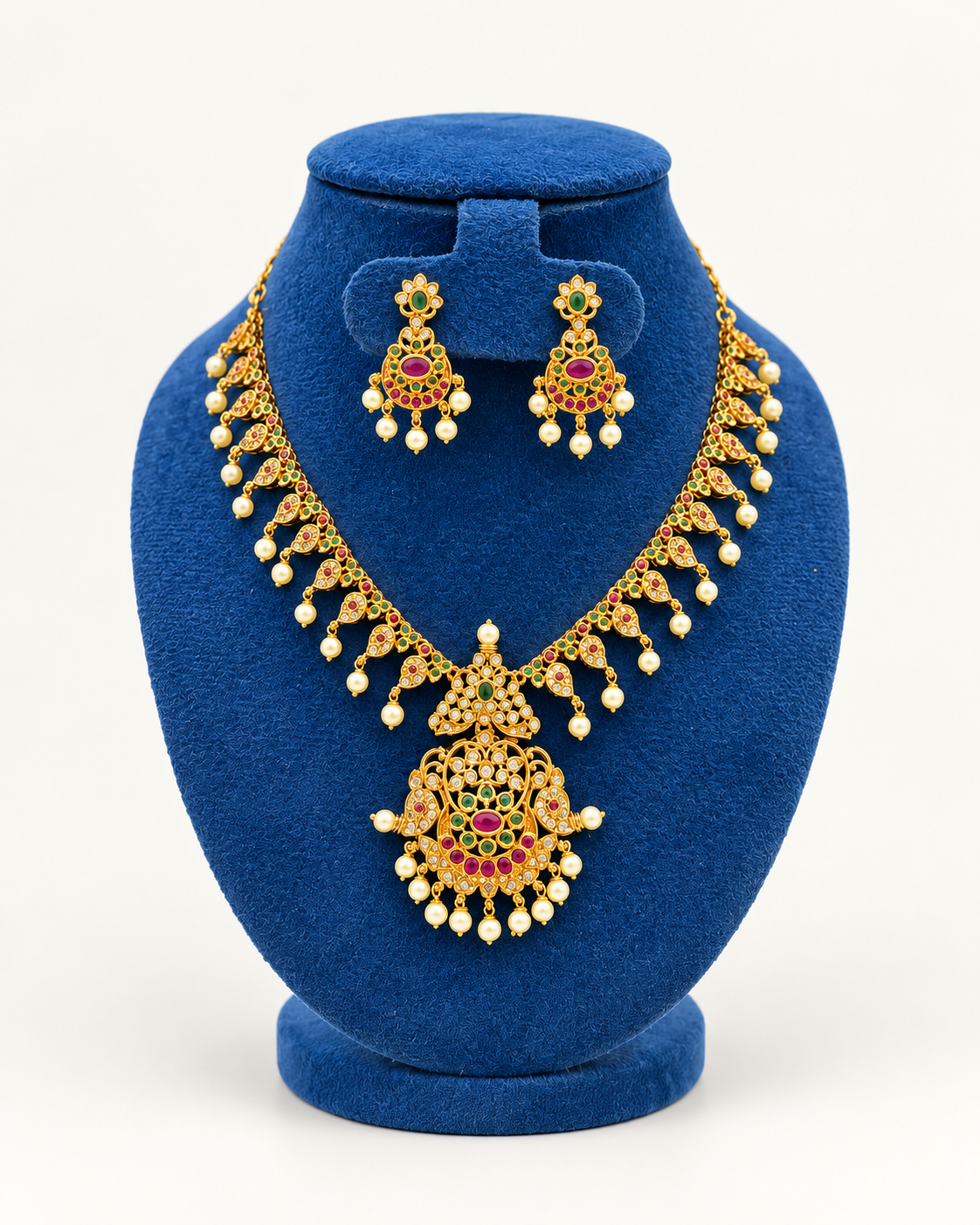Kaveri mango fringe statement necklace set with earrings in multicolor on a blue velvet display stand