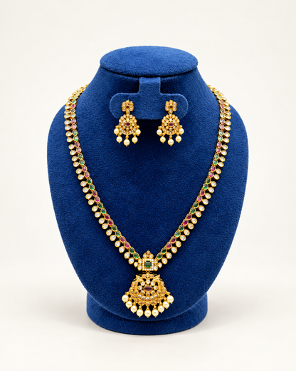 Kaveri long leaf stone pearl pendant necklace set with earrings in multicolor on a blue velvet display stand