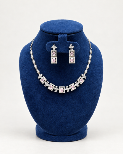 Kaveri square halo necklace set with long earrings in pink on a blue velvet display stand